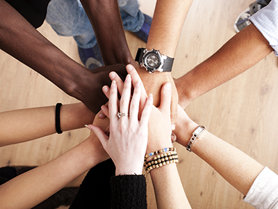 diverse group with hands together